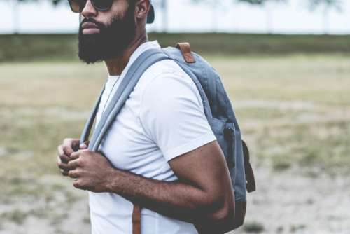 guy man beard sunglasses backpack