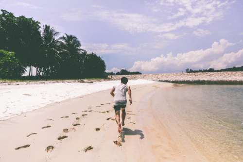 boy guy running beach sand