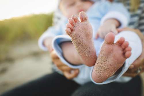 baby feet sand family people