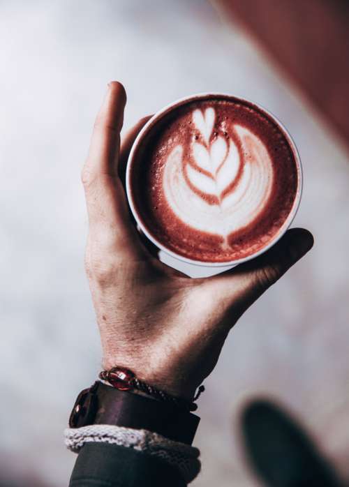 latte art hand close up drink