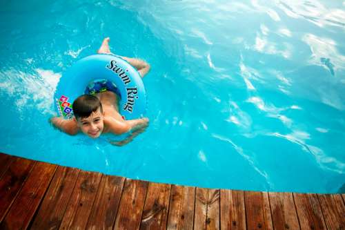 young boy swimming pool water