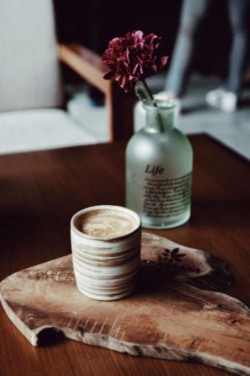 coffee flowers bottle wood table