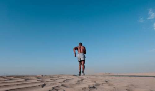 black man running desert fitness