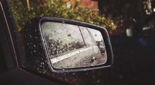 car mirror raining rain drops wet