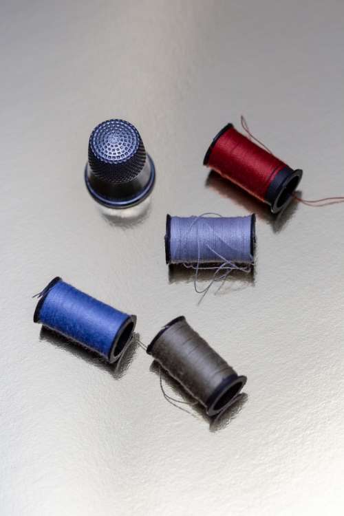 sewing thread thimble spools stitching