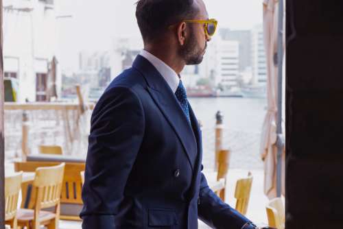 businessman blue suit power sunglasses