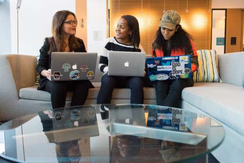 woman developers laptop meeting desk