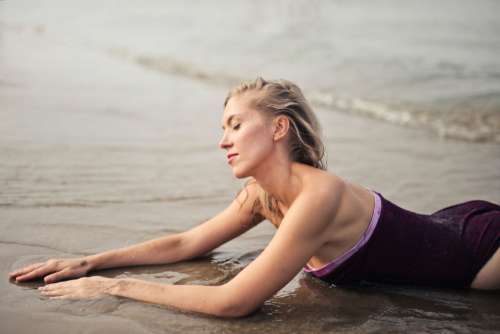 blond woman beach swimsuit sand