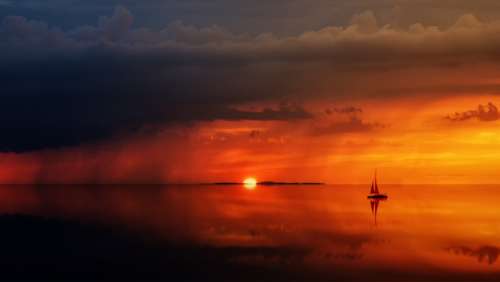 ship ocean sunset rain clouds