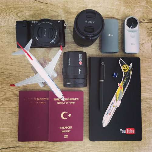 airplane business camera passport notebook