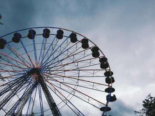 ferris wheel amusement park fair sky clouds