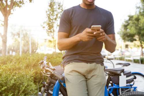 black man outside mobile phone technology type