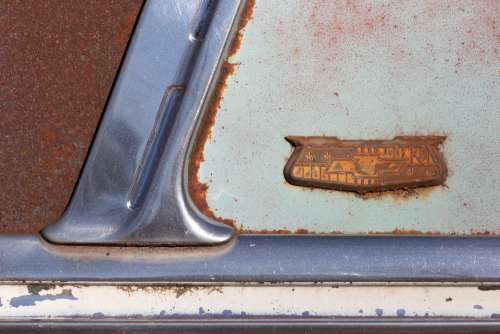 antique rust car chevy badge