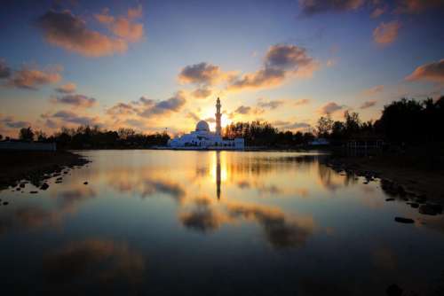 tower building water reflection dark