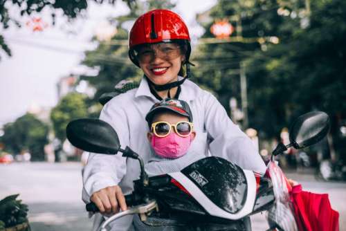 mother son riding motorcycle helmet