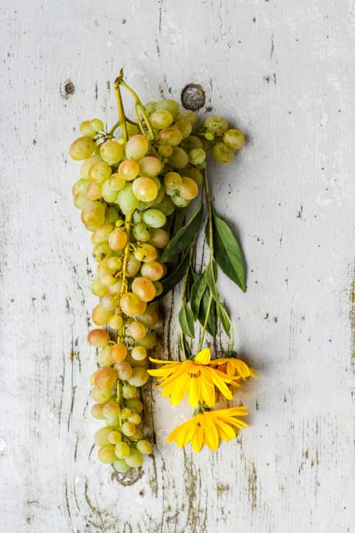 flat lay flowers grapes rustic table