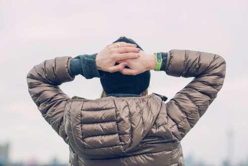 woman hands head smart watch