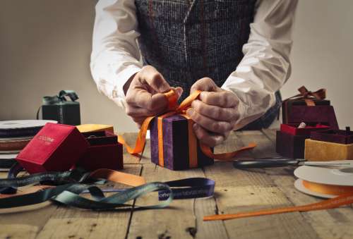 man wrapping gift present craftsman