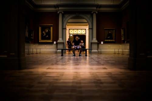 people man sitting alone museum