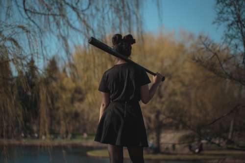 woman baseball bat outdoors nature