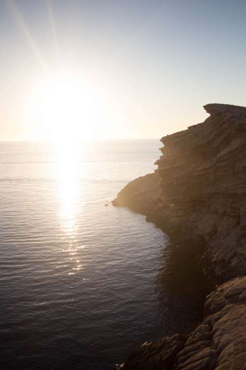 rocky shore sunset water ocean