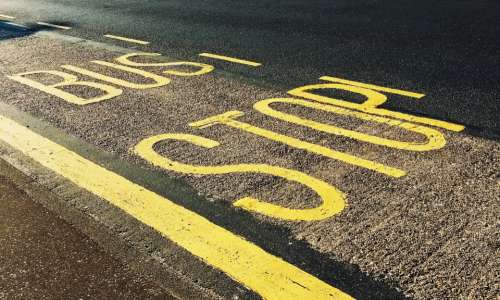 road bus stop road road sign street