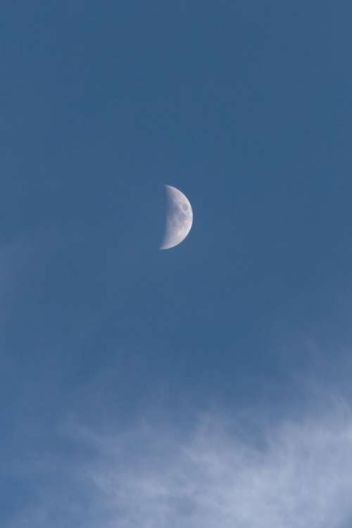 moon blue sky clouds daytime