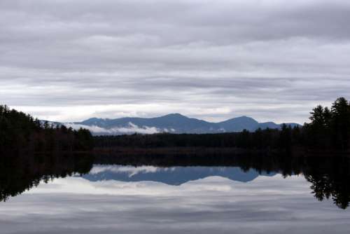 clouds mountain lake reflection water