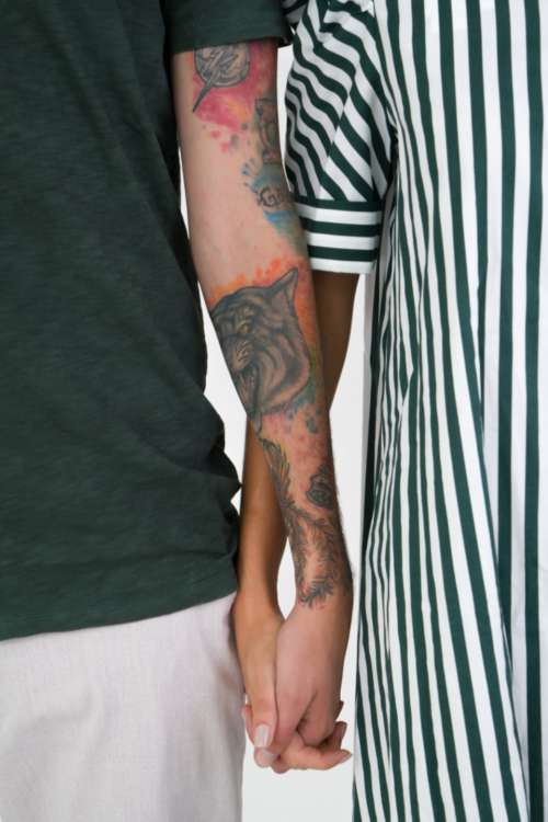 Couple holding hands tattoos young couple no face