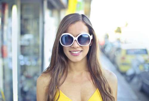 woman sunglasses smile yellow dress
