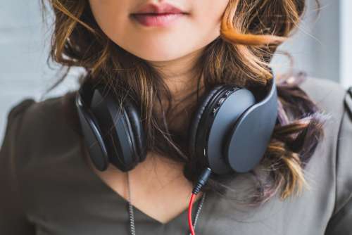 woman headphones music brown hair pretty