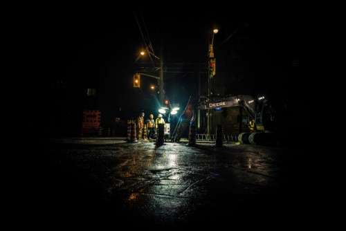 dark night construction people road