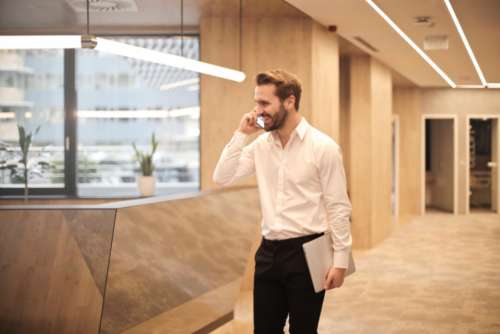 man office phone beard laptop