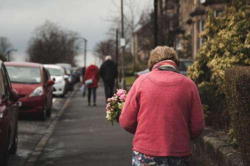 people old woman walking flower