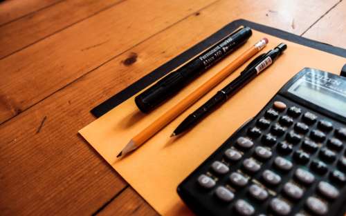 calculator pencil pen paper table