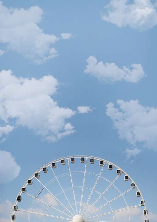 big wheel blue sky clouds