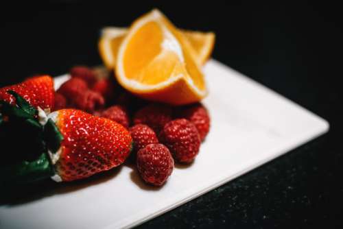 orange strawberry raspberry plate fruit
