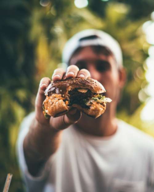 man eating burger hamburger tasty