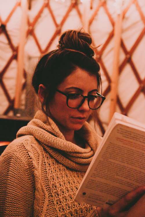 woman glasses reading book jumper