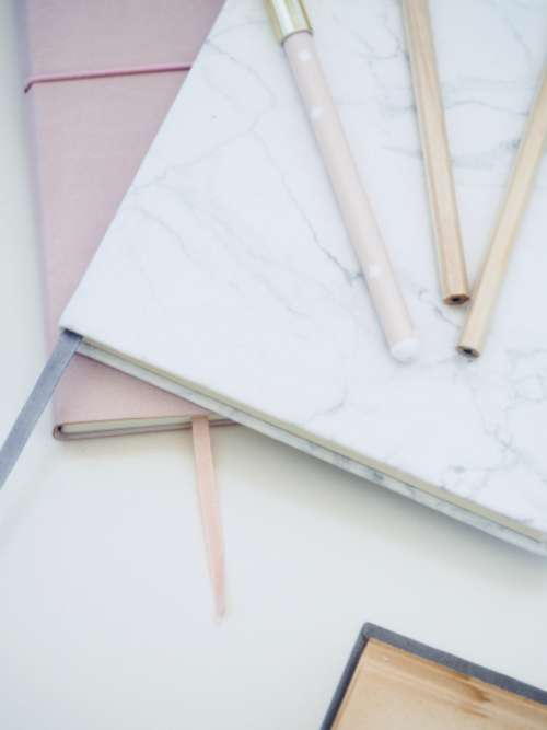 pink white notepad pen wirite dots