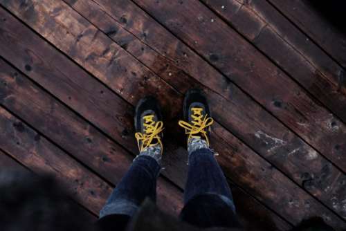 shoes yellow laces wood floor