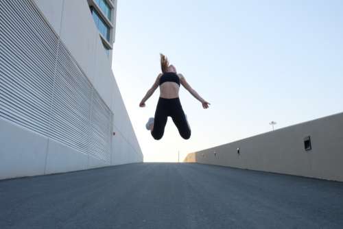 fitness woman jumping street road