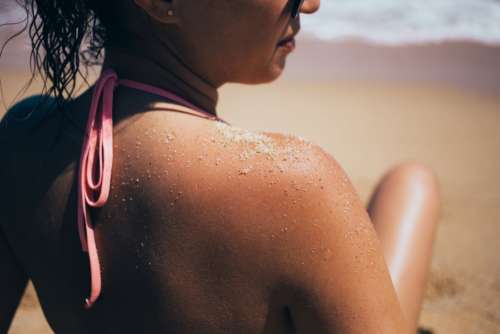woman close up beach sand tan