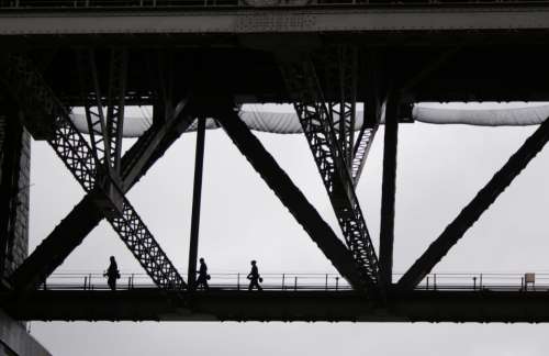 people crossing bridge monochromatic silhouette