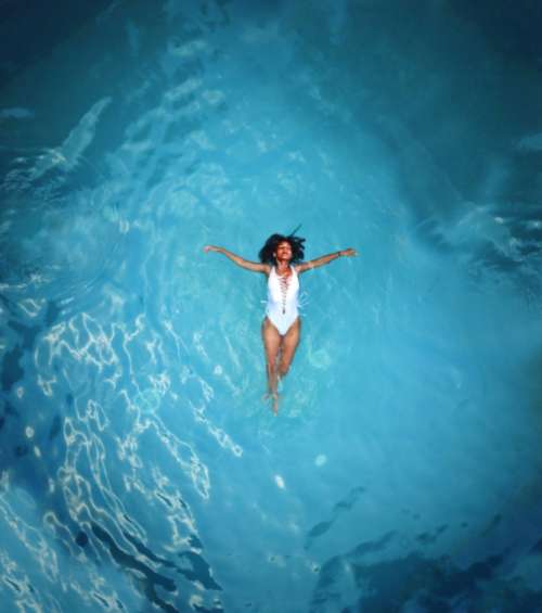 woman swimming alone isolated pool