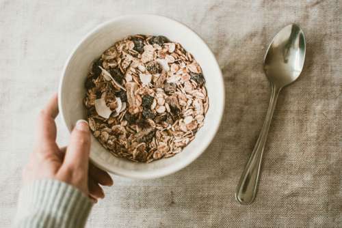 woman holding muesli cereal breakfast