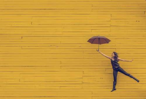 yellow wood wall umbrella people