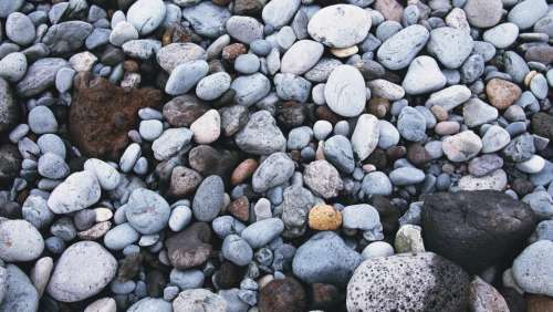 rocks pebbles beach sand ocean