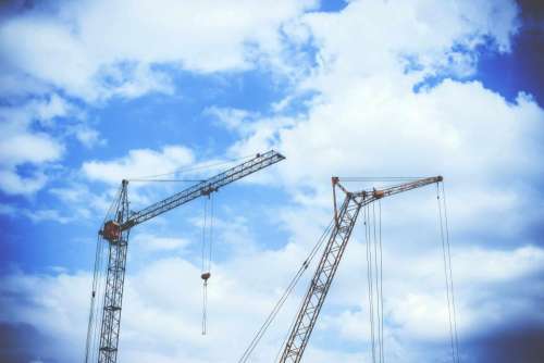 blue sky clouds crane construction