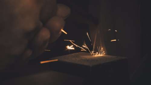 man working long exposure metal sparks